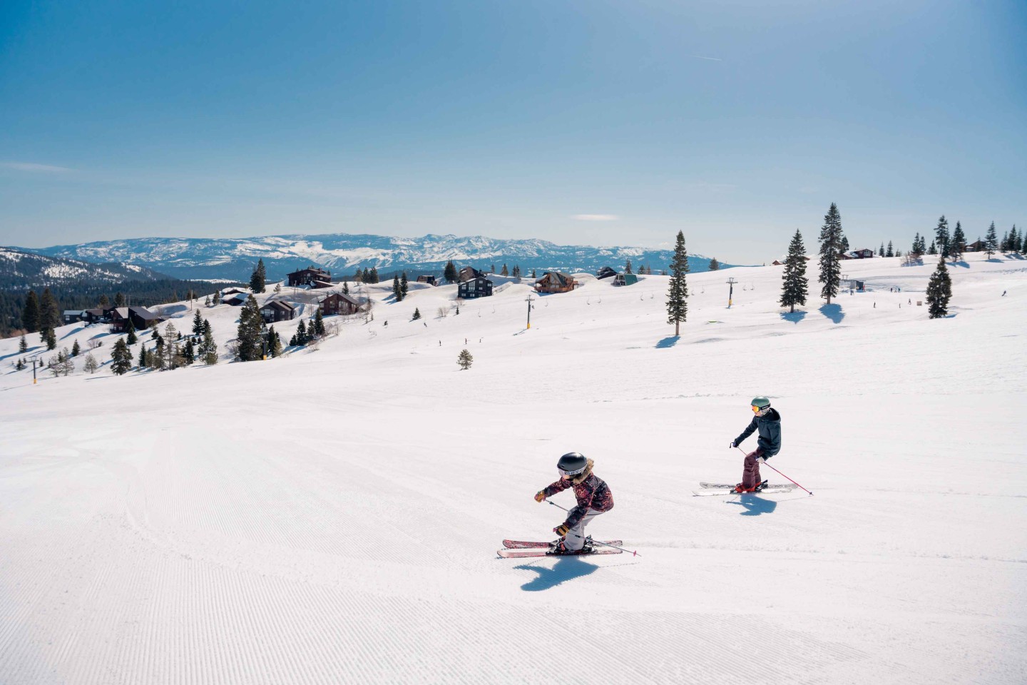 2 skiers on ski run