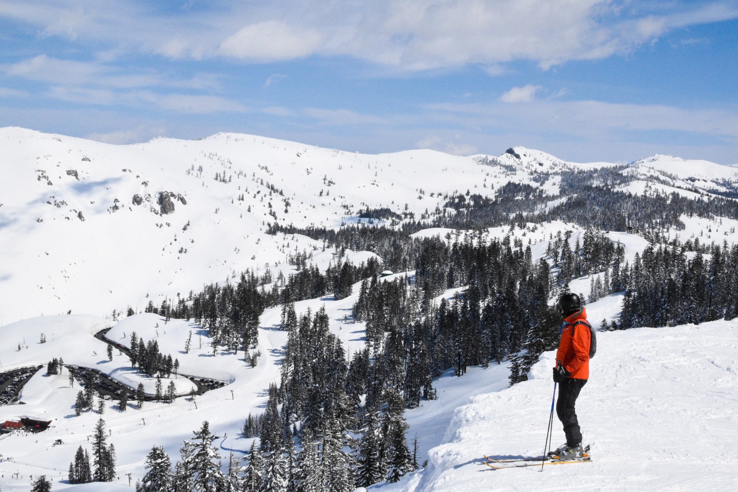 skier looking over mountain area on clear winter day