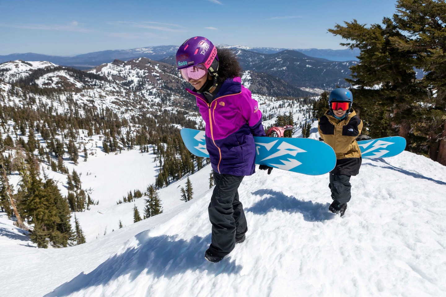 Snowboarders hiking with snowboards